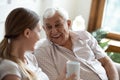 Happy old man talking with smiling grown up adult daughter. Royalty Free Stock Photo