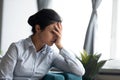 Unhappy stressed millennial indian ethnicity woman hiding face in hands.