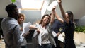 Laughing international group of employees celebrating achievement. Royalty Free Stock Photo