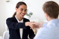 Happy female mixed race manager shaking hands with job applicant. Royalty Free Stock Photo