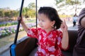 Head shot Happy girl sat with sweet smile on a rickshaw in park.