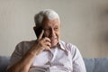 Joyful sincere old man holding cellphone call conversation.