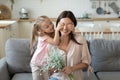 Little girl covering eyes of smiling young mother. Royalty Free Stock Photo