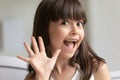 Head shot little girl vlogger waving hand, looking at camera