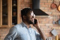 Head shot overjoyed African American man talking on phone