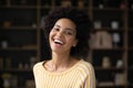 Head shot overjoyed young African American woman showing perfect smile.