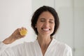 Head shot overjoyed woman holding lemon slice, recommending organic product