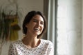 Head shot of overjoyed woman laughing at joke, having fun