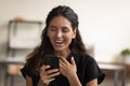 Head shot overjoyed woman looking at phone screen, good news