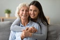 Head shot portrait smiling granddaughter embracing happy grandmother Royalty Free Stock Photo