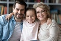 Head shot portrait of bonding smiling intergenerational family.