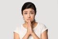 Head shot portrait Indian girl joining hands in praying gesture Royalty Free Stock Photo