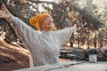 Head shot portrait close up of middle age woman enjoying and relaxing sitting at table in the nature in the forest of mountain. Royalty Free Stock Photo