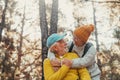 Head shot portrait close up of old people smiling and enjoying looking each other in the forest of mountain. Cute couple of mature