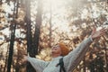 Head shot portrait close up of one middle age woman looking at the trees enjoying nature alone in the forest. Old female with Royalty Free Stock Photo