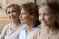 Head shot portrait smiling mature woman with daughter and granddaughter Royalty Free Stock Photo