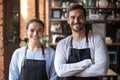 Head shot portrait of coffeehouse workers, smiling waiter and waitress