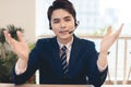 Head shot portrait confident young businessman  looking at camera and talking by headphone Royalty Free Stock Photo