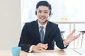 Head shot portrait confident young businessman  looking at camera and talking by headphon Royalty Free Stock Photo