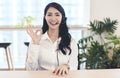 Head shot portrait confident young businesswoman looking at camera and talking by headphone