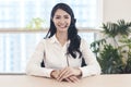 Head shot portrait confident young businesswoman  looking at camera and talking by headphone Royalty Free Stock Photo