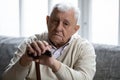 Head shot portrait depressed lonely elderly man with cane