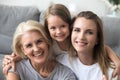 Happy laughing granddaughter mother and grandmother looking at camera Royalty Free Stock Photo