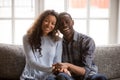 Head shot portrait happy African American couple in love sitting