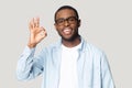 Head shot portrait happy African American man showing ok gesture Royalty Free Stock Photo