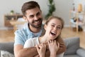 Head shot portrait of happy excited young couple in love at home