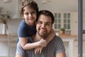 Head shot portrait happy father piggybacking cute little son Royalty Free Stock Photo