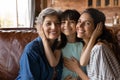 Head shot portrait happy three generations of women hugging