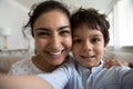 Head shot portrait Indian mother with son taking selfie together