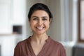 Head shot portrait Indian woman with healthy toothy smile