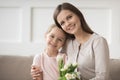 Head shot portrait mother and daughter with bouquet of flowers Royalty Free Stock Photo