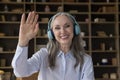 Head shot portrait older woman in headphones make video call Royalty Free Stock Photo