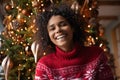 Head shot portrait overjoyed African American woman laughing, celebrating Christmas