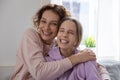 Head shot portrait overjoyed mother and happy teenage daughter hugging