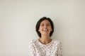 Head shot portrait overjoyed woman laughing on grey studio background