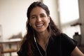 Head shot portrait overjoyed woman wearing earphones laughing at camera