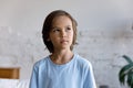 Headshot portrait pensive little boy staring aside looking thoughtful