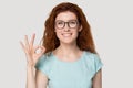 Head shot portrait young smiling woman showing okey gesture. Royalty Free Stock Photo