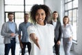 Head shot portrait smiling African American businesswoman offering handshake Royalty Free Stock Photo