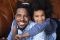 Head shot portrait smiling African American father piggy backing daughter Royalty Free Stock Photo