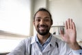 Head shot portrait smiling African American man doctor waving hand Royalty Free Stock Photo