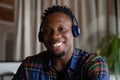 Head shot portrait of smiling African American man in headphones Royalty Free Stock Photo