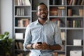 Head shot portrait smiling African American man holding phone Royalty Free Stock Photo