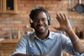 Head shot portrait smiling African American man wearing headphones greeting Royalty Free Stock Photo