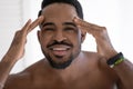 Head shot portrait African American young man checking wrinkles Royalty Free Stock Photo