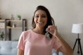 Head shot portrait of smiling Arabian woman showing keys Royalty Free Stock Photo